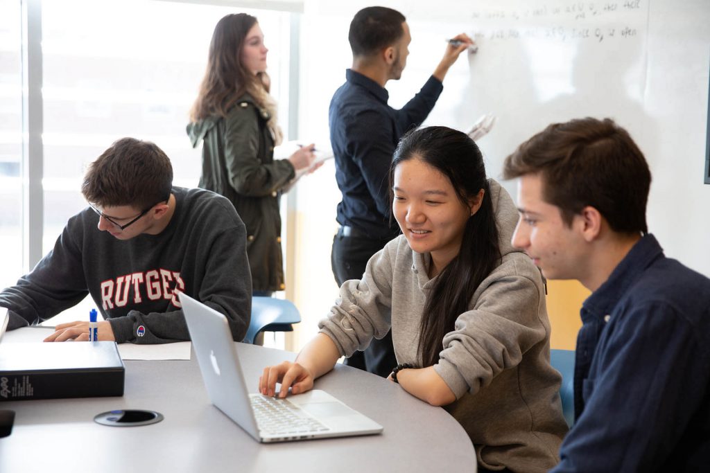 College students wokring on a project together.