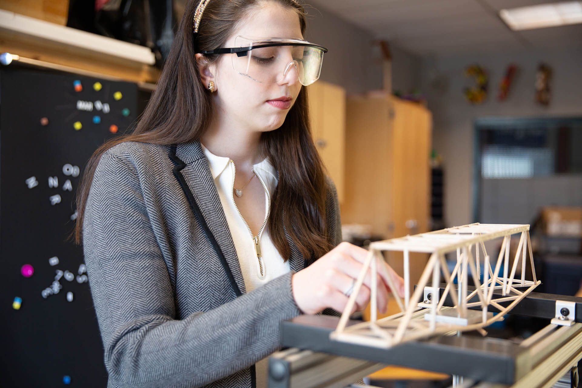Woman working on designing a bridge.