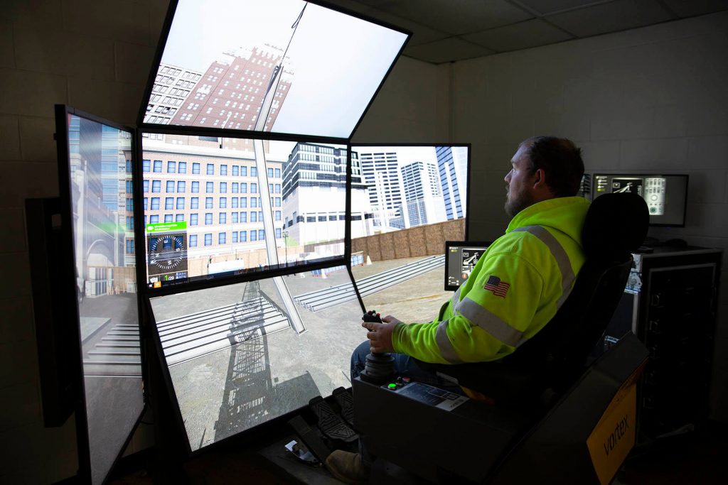 Man practicing operator machinery on a simulator.