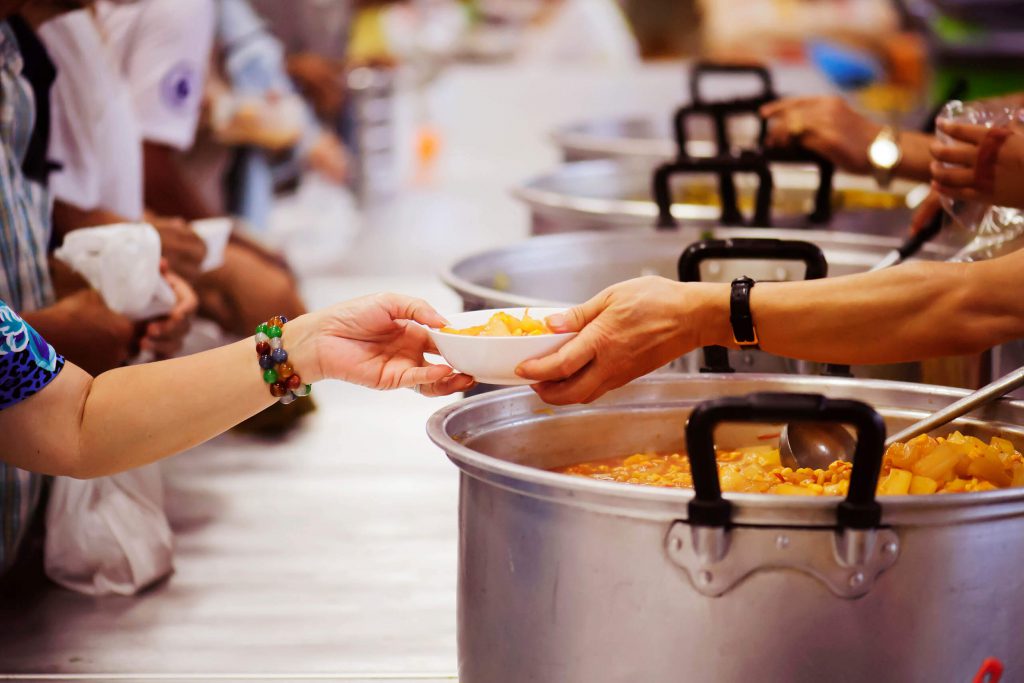 People handing out food at a food pantry.
