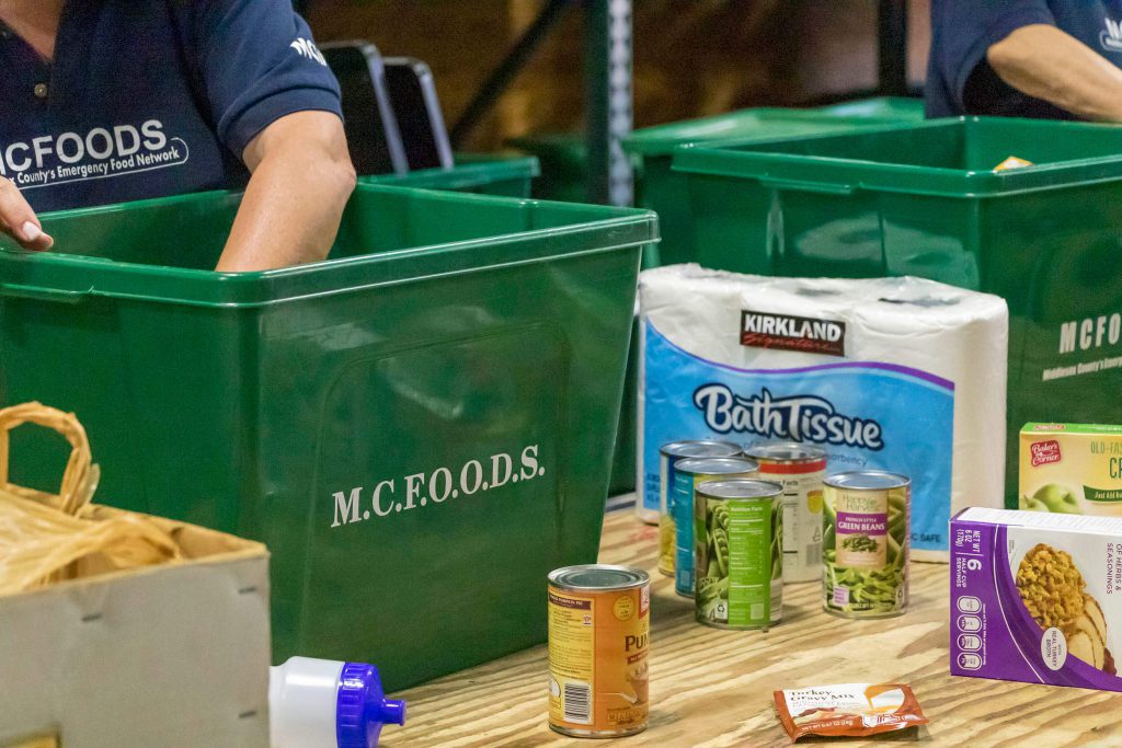 People handing food at a food pantry.
