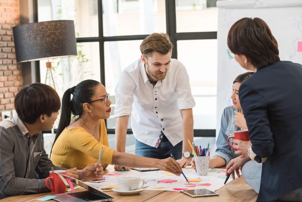 A diverse team of people working in a conference room.
