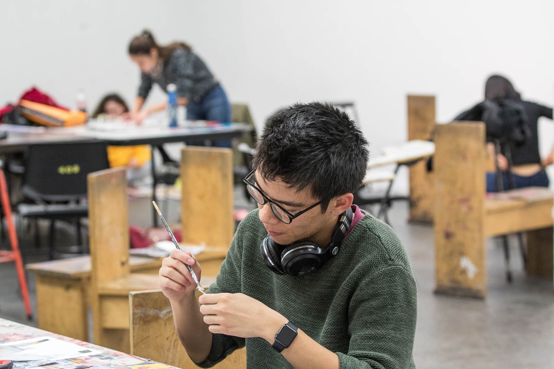 A painting student working in a studio.