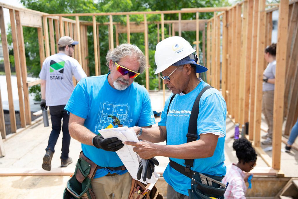 Construction workers looking a blueprints.