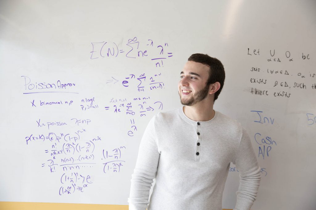 A student infront of a whiteboard at Rutgers University.