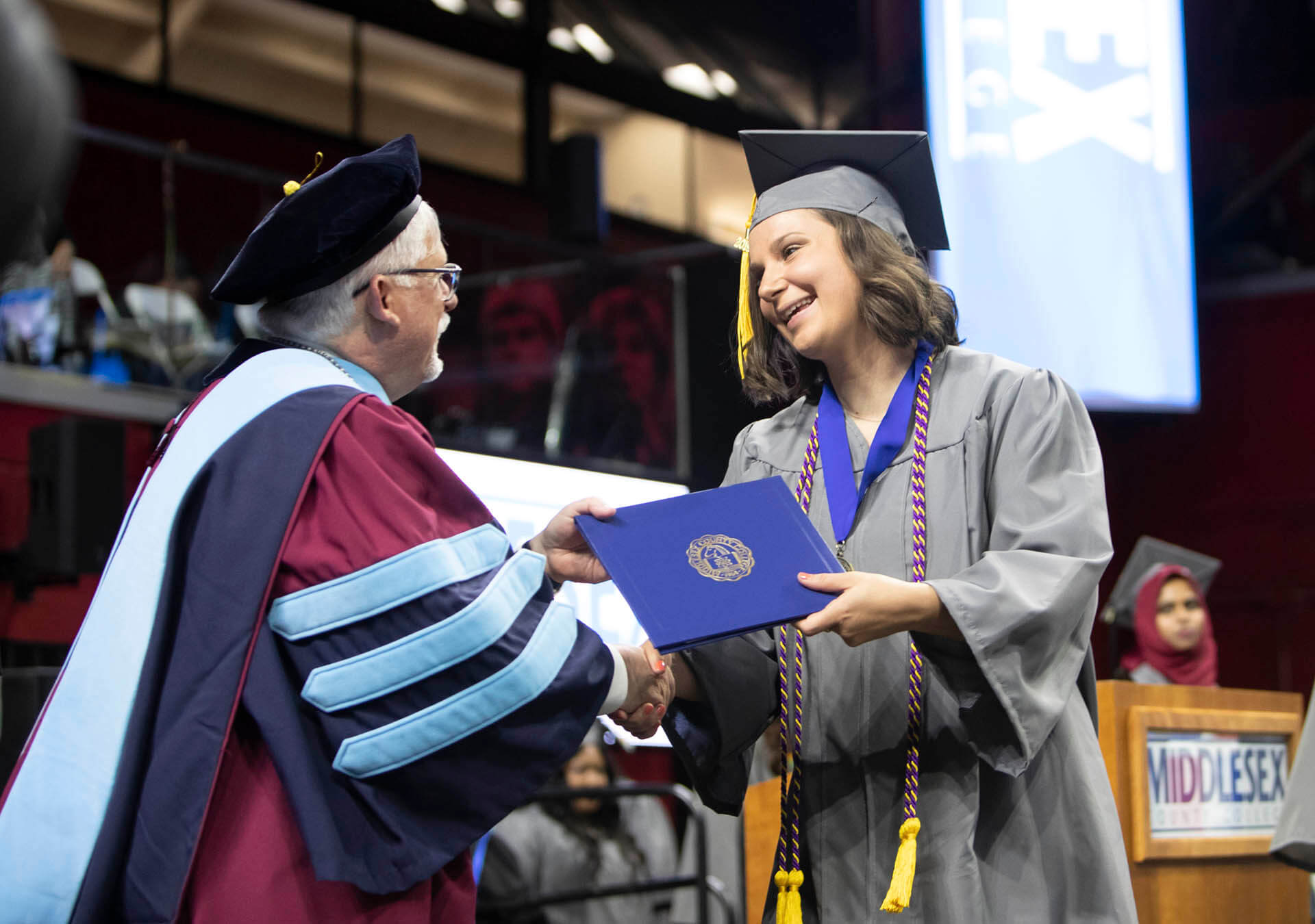 A student from Middlesex College receiving her diploma.