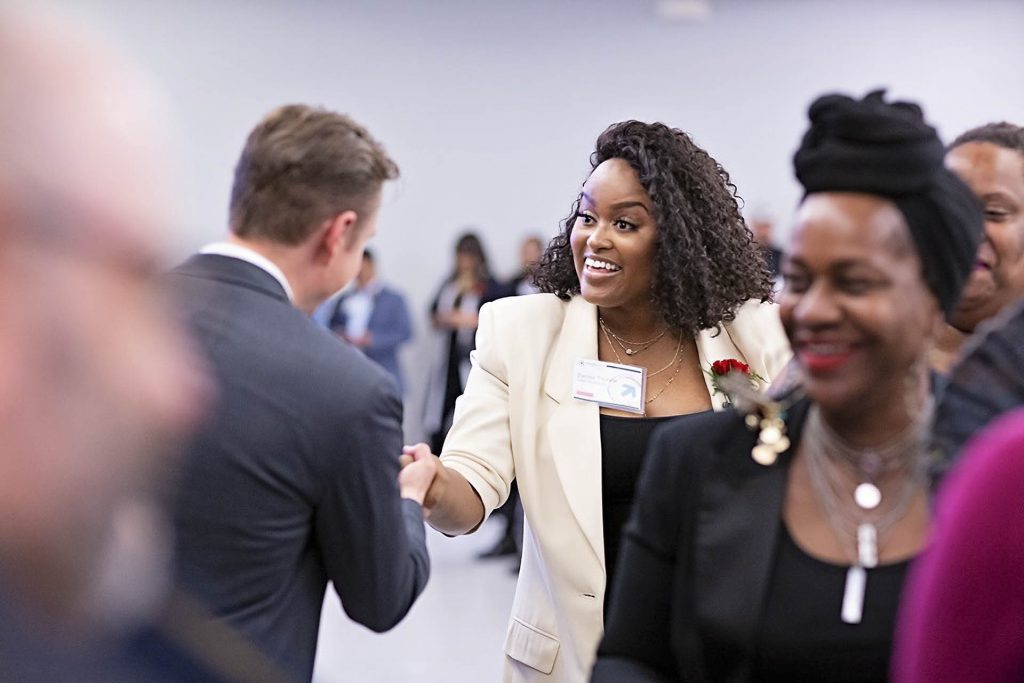 Individuals network at a career fair.